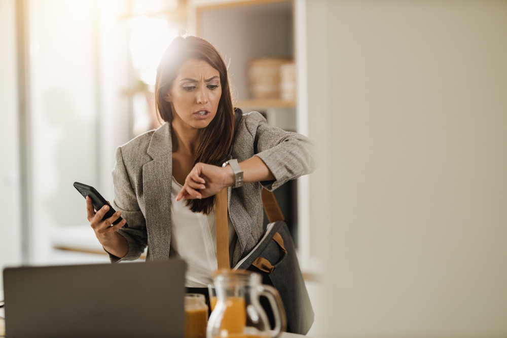 Shot,Of,A,Multi-tasking,Young,Business,Woman,Looking,On,Watch